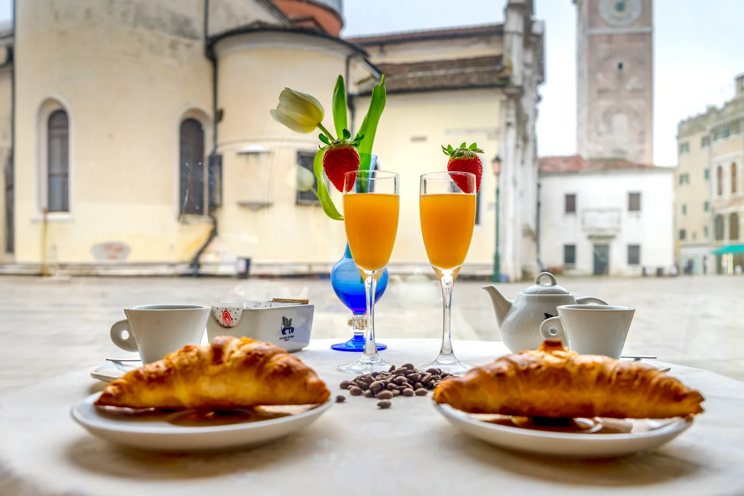 Croissants and fresh juice at the breakfast room table overlooking the campo, Palazzo Vitturi