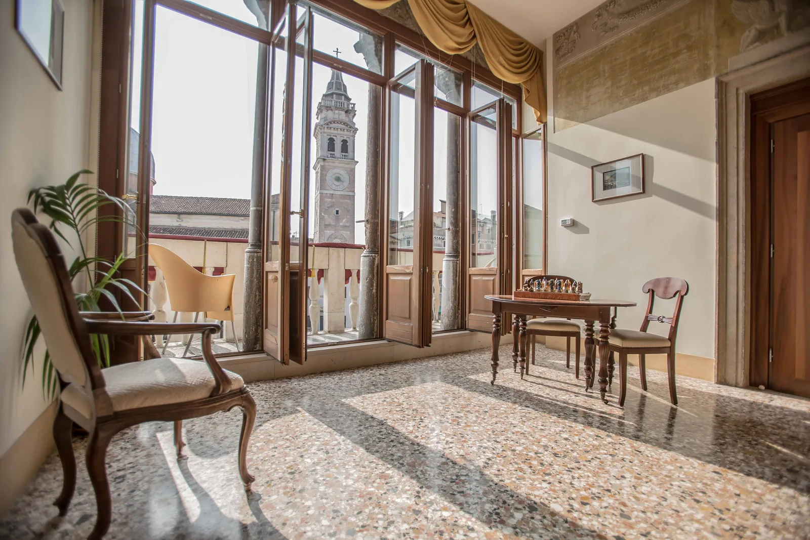 The noble hall of Palazzo Vitturi with a view of the Santa Maria Formosa bell tower